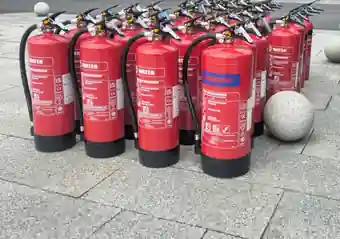 A batch of serviced water and powder fire extinguishers