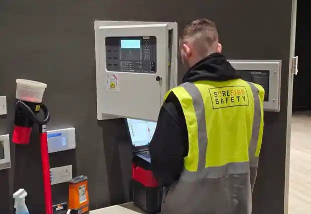 A Surefire Safety engineer commissioning an addressable fire alarm panel